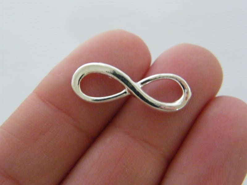 12 Infinity charms or connectors  silver plated tone I28