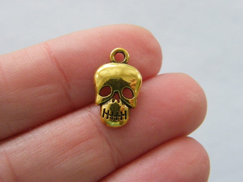 12 Skull charms antique gold tone HC39