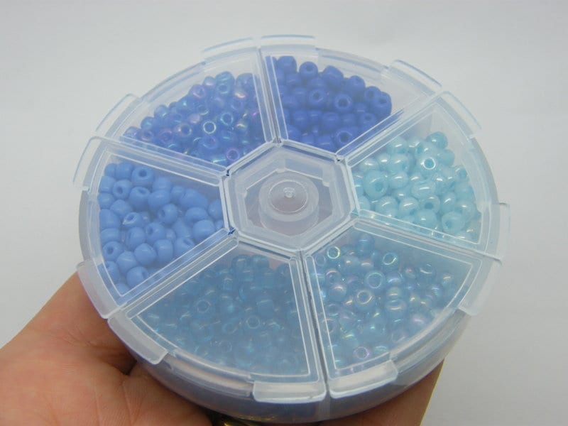 1 Storage box with 6 different blue clear 4mm seed beads