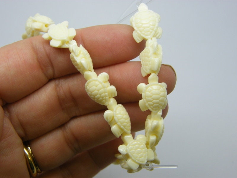 18 Turtle spacer beads synthetic resin  creme FF