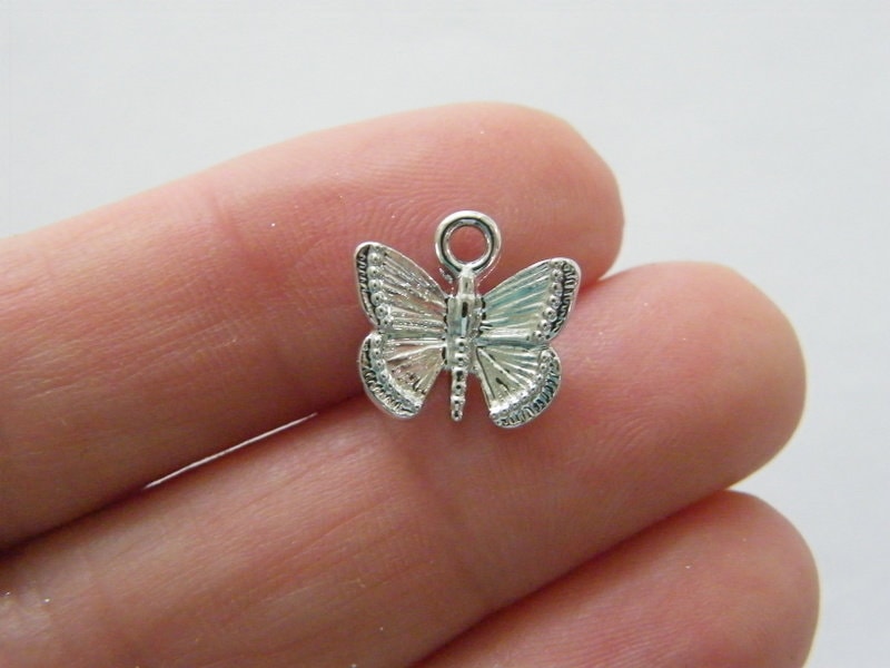 10 Butterfly charms silver tone A398