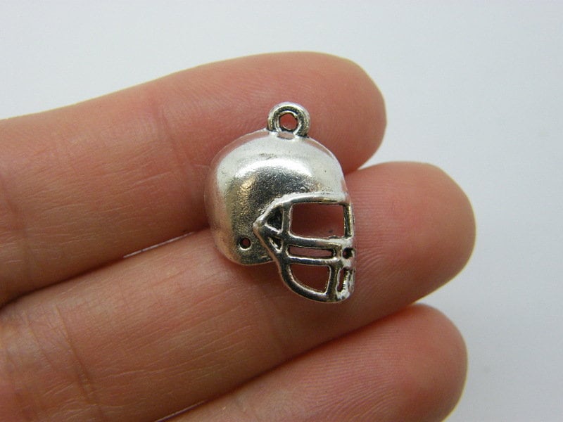 8 American football helmet charms antique silver tone SP30
