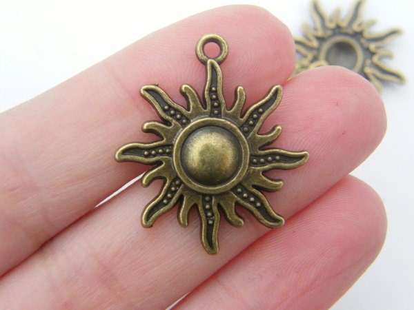 4 Sun pendants antique bronze tone S32