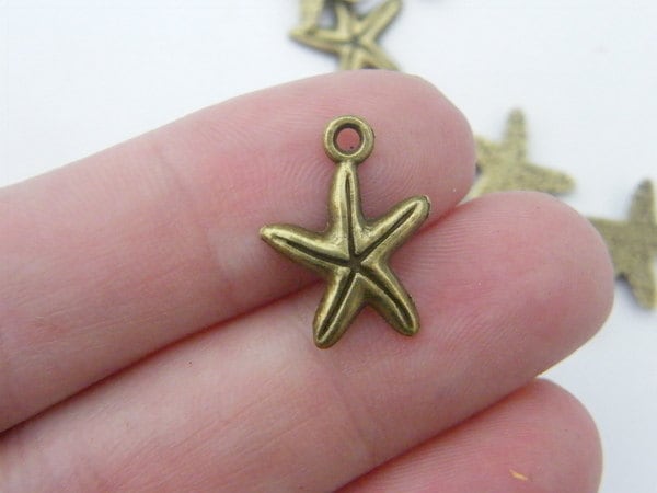 16 Starfish charms antique bronze tone FF650
