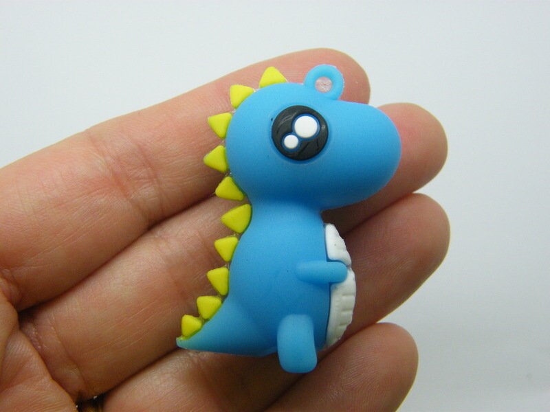 4 Dinosaur pendants blue PVC plastic 08C