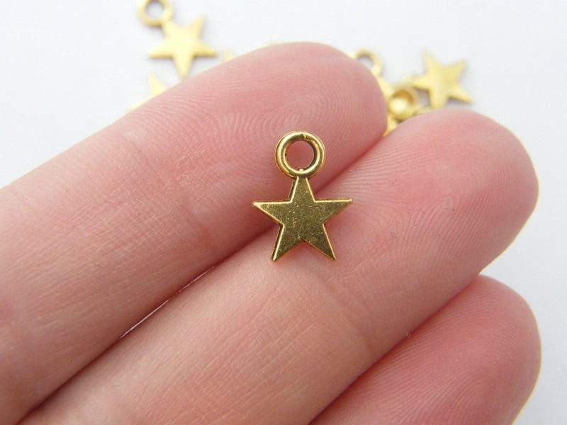14 Star charms antique gold tone S271