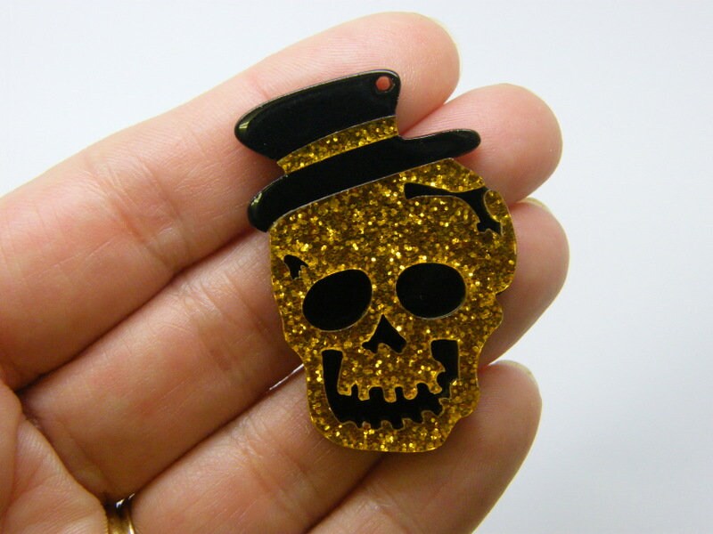 2 Skull pendants gold glitter and black  acrylic HC583
