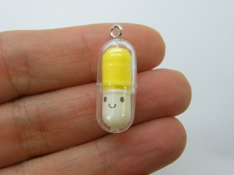 6 Face capsule in a capsule charms yellow white clear plastic M585
