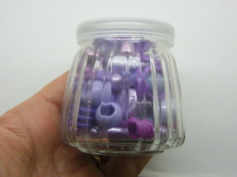 1 Glass bottle jar with plastic lid 6.85 x 6.8cm with random purple beads