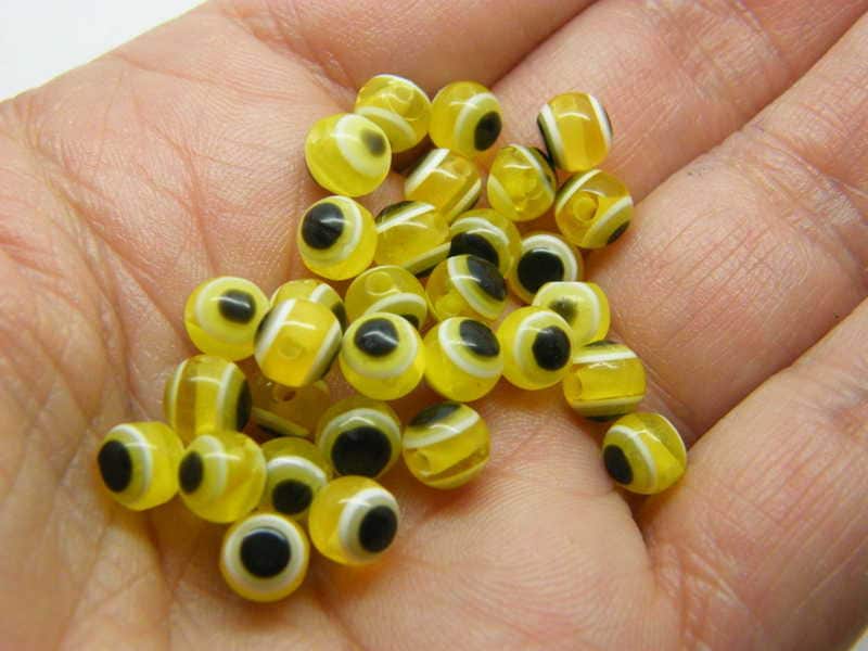 100 Evil eye 6mm beads yellow white and black resin AB