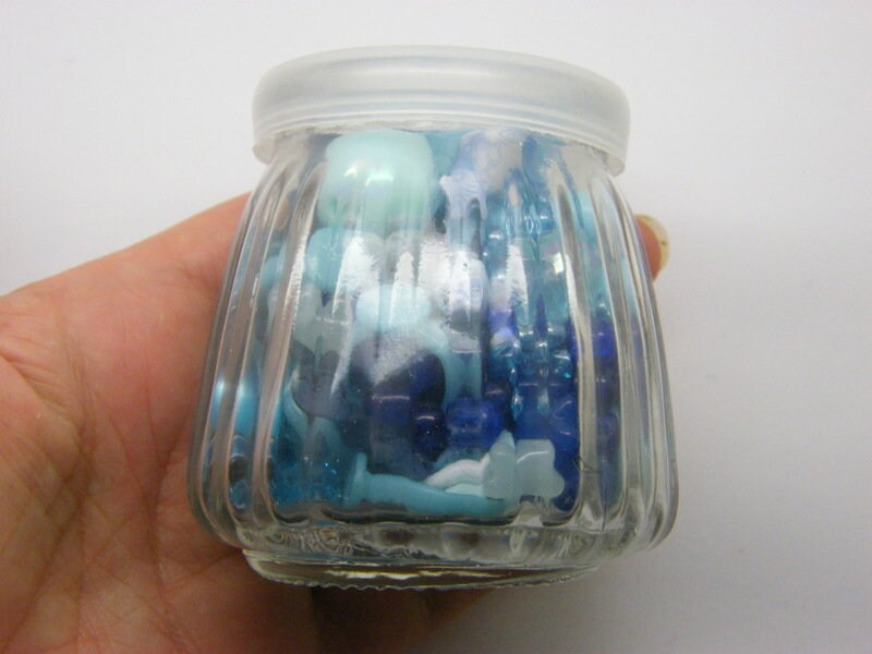 1 Glass bottle jar with plastic lid 6.85 x 6.8cm with random blue beads
