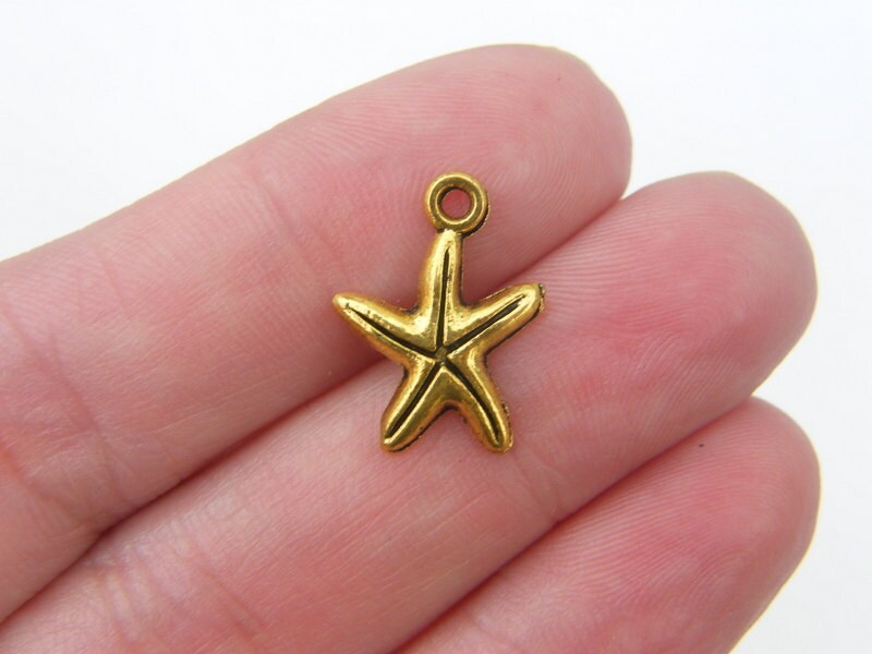 14 Starfish charms antique gold tone FF628