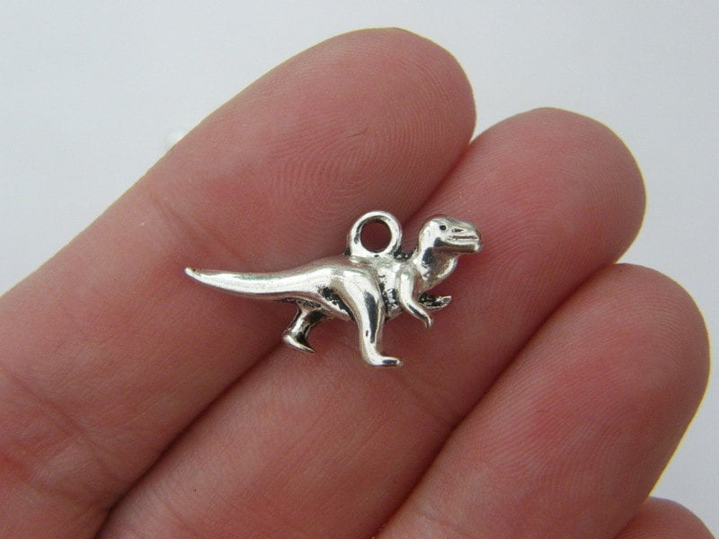 8 Dinosaur charms antique silver tone A176