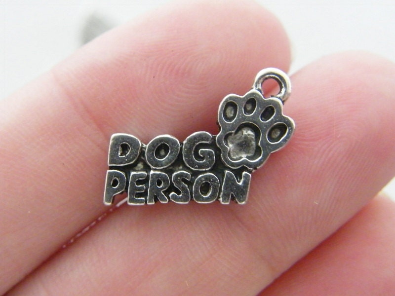 8 Dog person charms antique silver tone A880