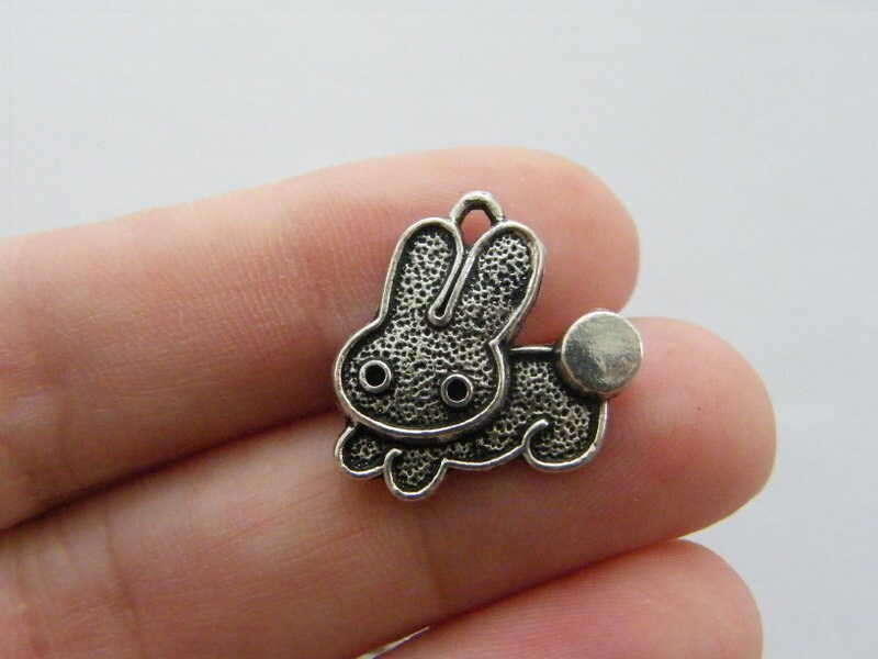 8 Rabbit charms antique silver tone A259