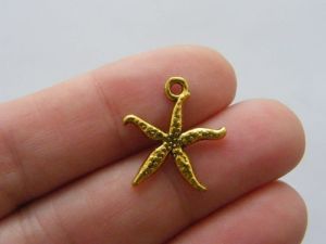 10 Starfish charms antique gold tone FF341