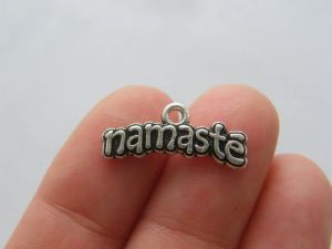 7 Namaste charms antique silver tone M257