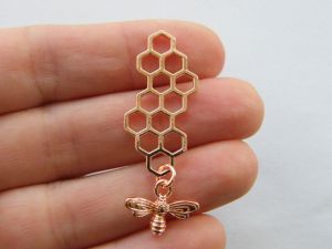 4 Bee and honeycomb charms rose gold tone A529
