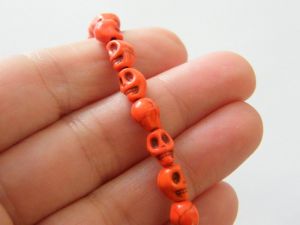 48  Orange skull beads 8 x 6mm SK11