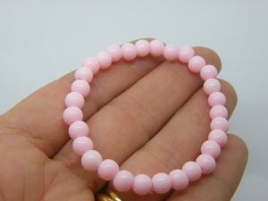 6 Pink beaded bracelets elasticated