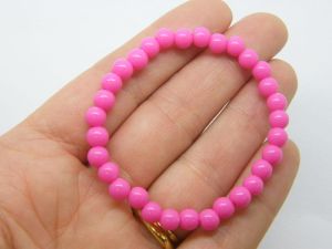 6 Fuchsia pink beaded bracelets elasticated