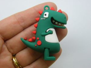 4 Dinosaur pendants dark green PVC plastic 02A