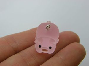 4 Pig lying down charms pink resin A406