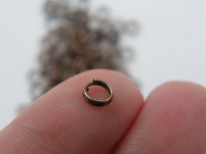 1000 Split rings 5mm antique copper tone FS203