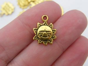 10 Sun charms antique gold tone S209