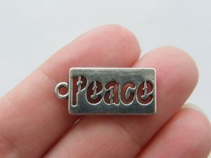 10 Peace charms antique silver tone M118