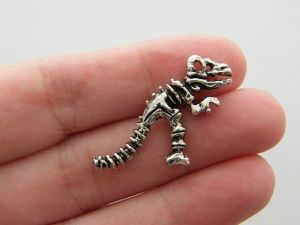 4 Dinosaur skeleton charms antique silver tone A964